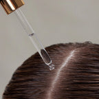 Hair Renew Daily Active Serum – clear dropper with rose gold cap, transparent serum on brown hair, neutral background – hair care