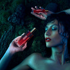 L'huile Démaquillante 1402 Slaventina – red glass bottle with gold cap, dark green moss background – makeup remover