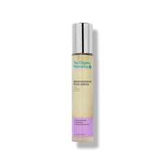 The Organic Pharmacy Brightening Plus Serum in a glass bottle with a silver cap on a white background, skin care