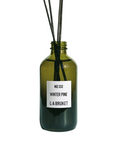 L:A Bruket No. 332 Winter Pine – grüne Glasflasche mit Rattanstäbchen, weißem Etikett und weißem Hintergrund – Raumduft