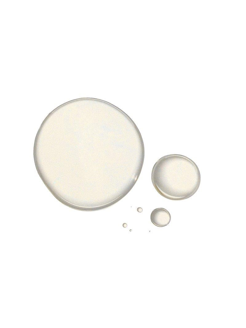 True Skin Radiant Priming Serum Light It Up: drops of clear serum on a white background, skin care.
