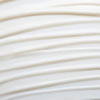 Texture of white Chamomile Cleansing Milk on a light background, gentle skin care