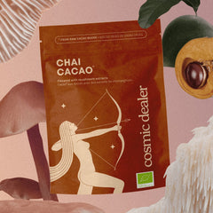 Cosmic Dealer Chai Cacao – brown stand-up pouch with archer illustration, pink background – face care