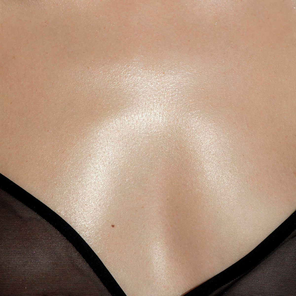 Glowing skin, a black bra, a neckline and chest.