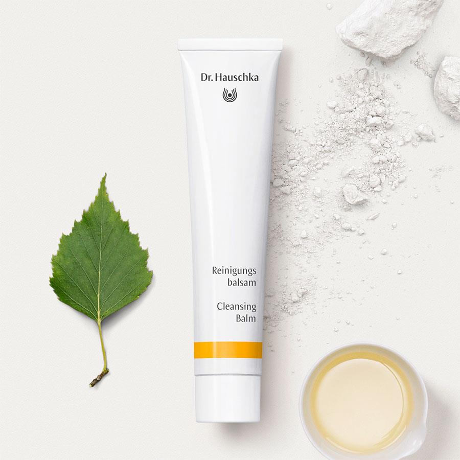 Dr. Hauschka Cleansing Balm – white tube with orange stripe, white cap, cream background – skin care