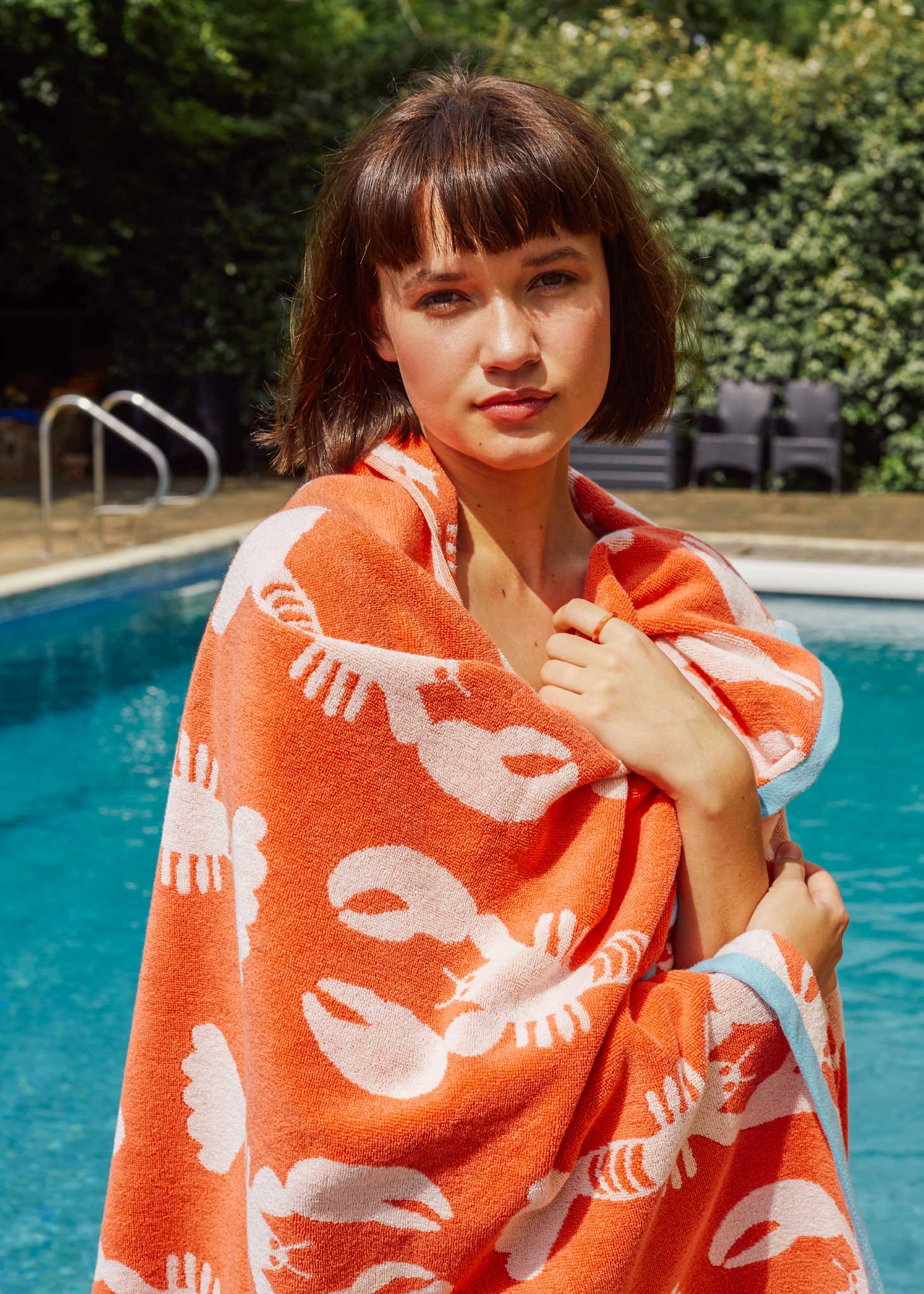 Lobster Organic Cotton Beach Towel – orange with white lobster print, worn by pool – beach fashion