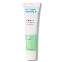 The Organic Pharmacy Blemish Gel in a white tube with green detail on a white background, skin care.