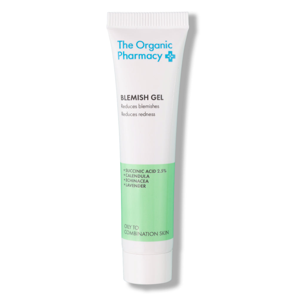 The Organic Pharmacy Blemish Gel in a white tube with green detail on a white background, skin care.