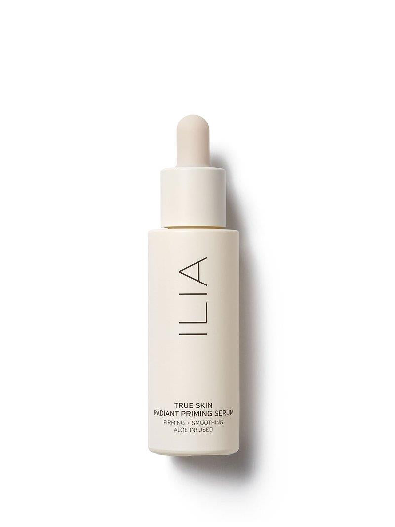 ILIA True Skin Radiant Priming Serum in a beige glass bottle with a dropper on a white background, skin care.
