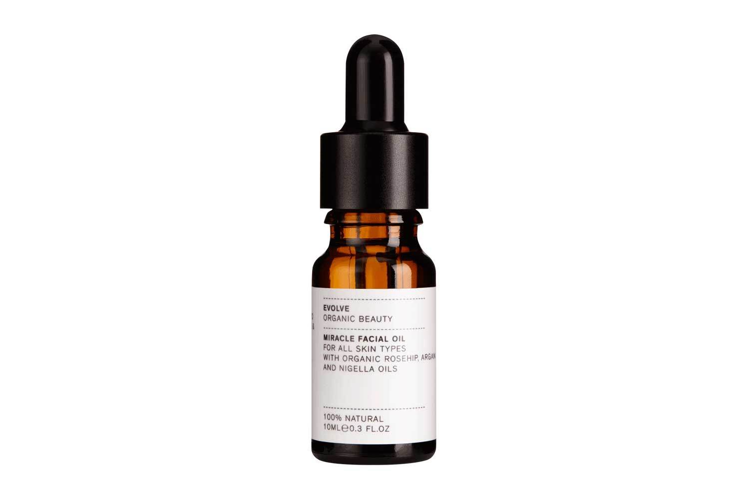 Evolve Organic Beauty Rosehip Miracle Facial Oil in a brown glass bottle with dropper on white background, skin care