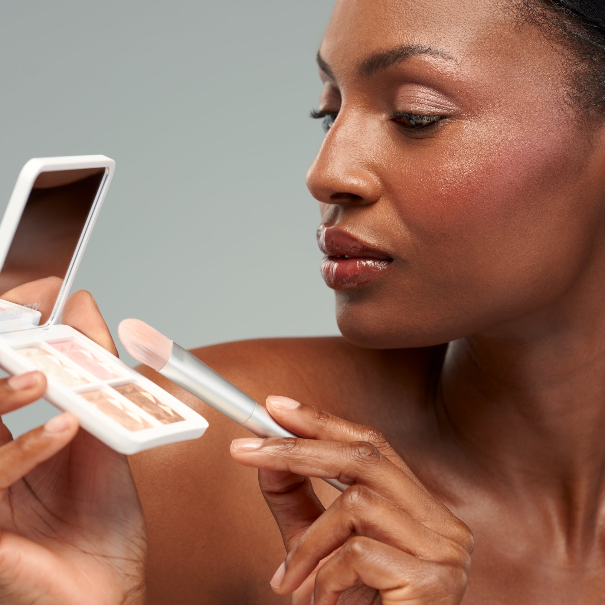 ReDimension Daily Glow Palette in a white palette against a grey background, makeup palette