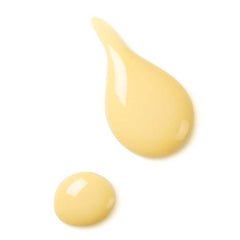 Activating Day Fluid – creamy texture, pale yellow drops on white background – skin care