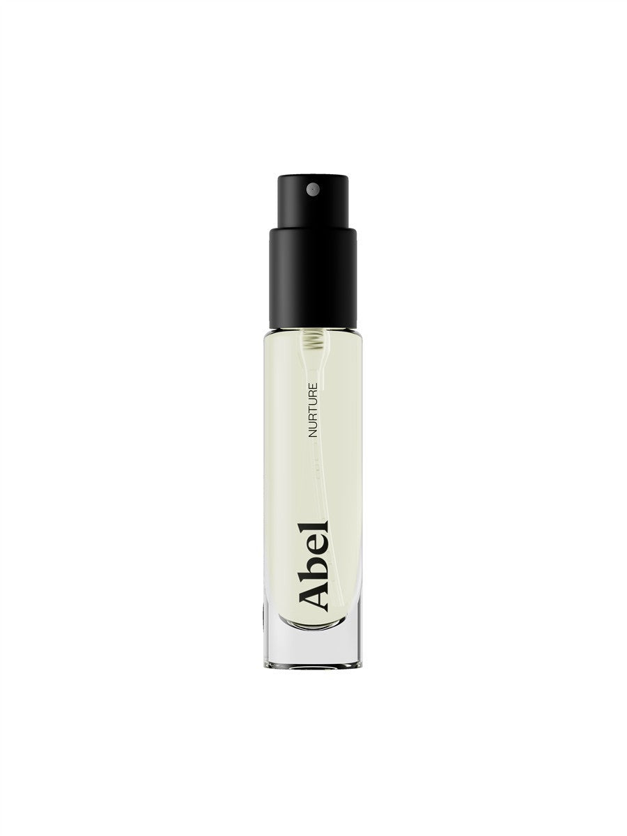 Abel Nurture Eau de Parfum – clear glass bottle with black spray nozzle, white background – perfume