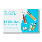 The Organic Pharmacy Essential Skincare Kit in einer blau-weißen Box mit Flaschen und Gläsern für die Hautpflege.