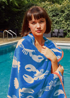 Lobster Blue Organic Cotton Washcloth – blue with lobster print, woman by pool – skin care