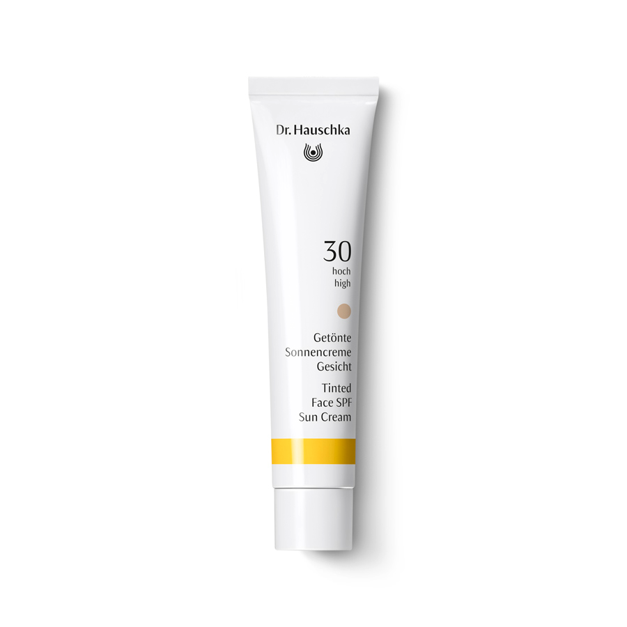 Dr. Hauschka Tinted Face Sun Cream SPF 30 – white tube with white cap, yellow accent stripe, white background – face care