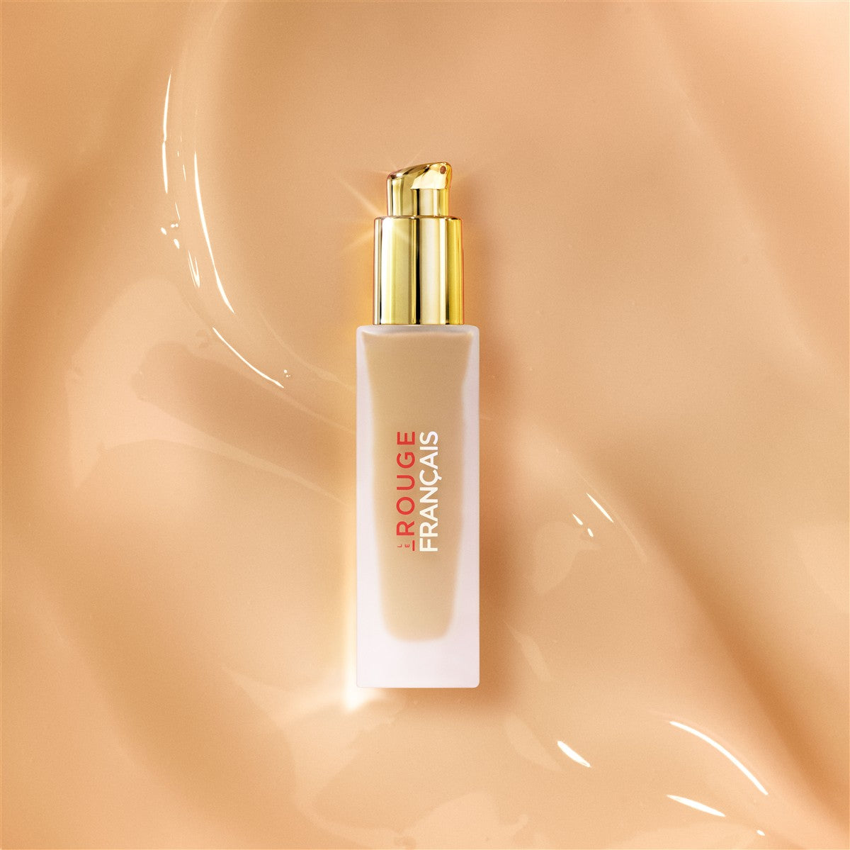 Le Rouge Français Le Fluide de Teint – beige bottle with gold pump, beige background – makeup
