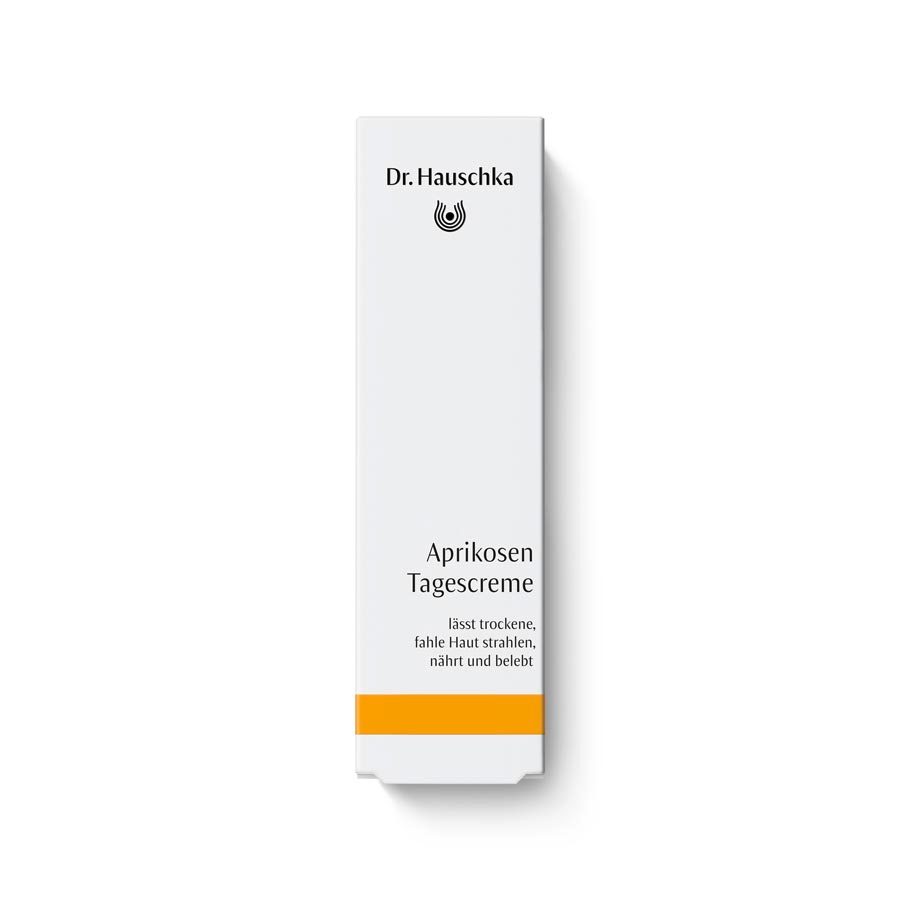 Dr. Hauschka Aprikosen Tagescreme – weiße Tube mit orangefarbenem Streifen, weißer Hintergrund – Hautpflege