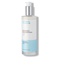 The Organic Pharmacy Chamomile Cleansing Milk in a bottle with pump on a white background, skin care