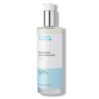 The Organic Pharmacy Chamomile Cleansing Milk in a bottle with pump on a white background, skin care