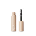 ILIA Fullest Volumizing Mascara beige tube with open wand on white background, eye makeup