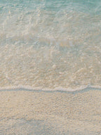 Sea water on a sandy beach - mood image for Korres Ionian Blue
