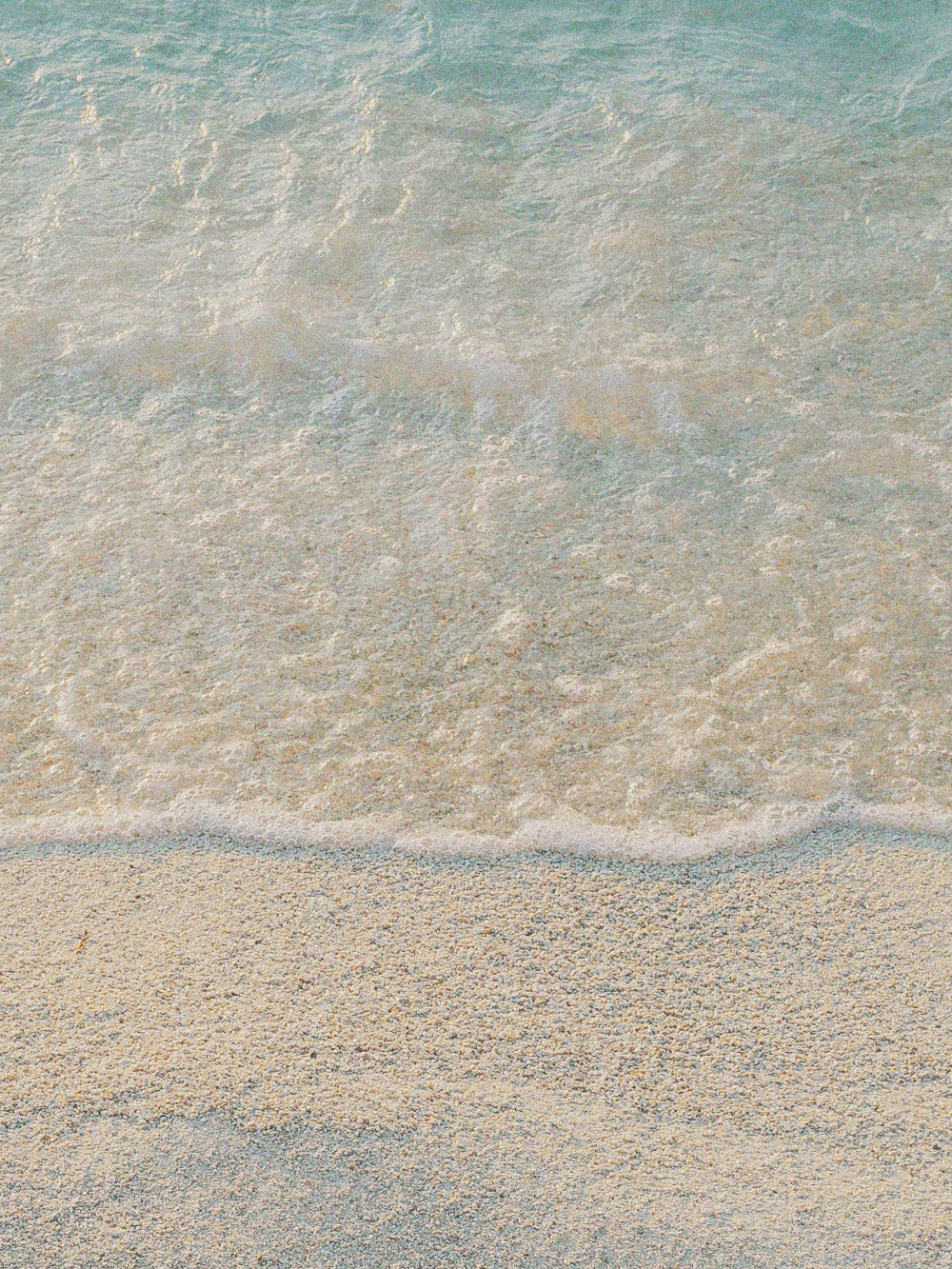 Sea water on a sandy beach - mood image for Korres Ionian Blue