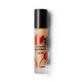 Susanne Kaufman Lip Oil in einer Flasche mit schwarzem Verschluss vor weißem Hintergrund, Lippenpflege