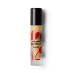 Susanne Kaufman Lip Oil in einer Flasche mit schwarzem Verschluss vor weißem Hintergrund, Lippenpflege