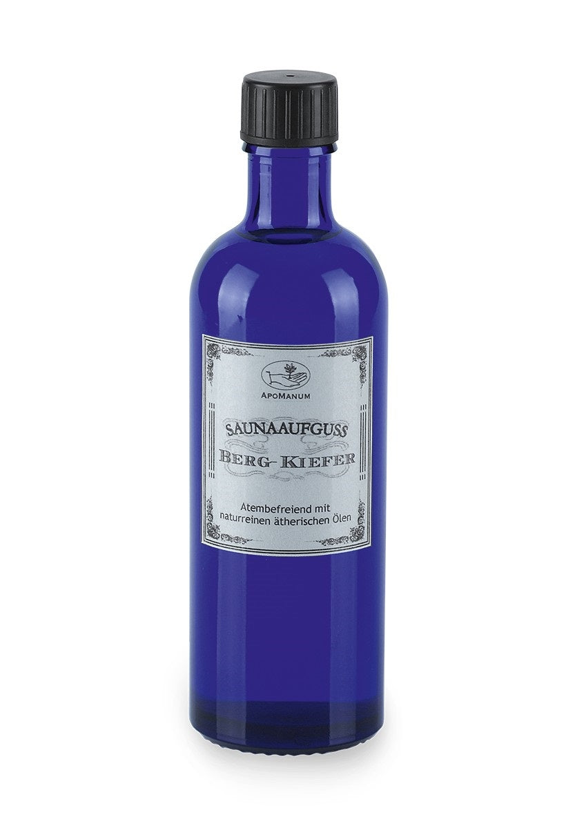 Apomanum Sauna Infusion Mountain Pine – blue glass bottle with black screw cap, white background – sauna aromatherapy