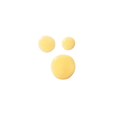 Body Lifting and Firming Body Treatment Créme: light yellow texture drops on a white background, skin care.