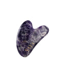 NAYA Amethyst Gua Sha, a purple polished amethyst massage stone on a white background.