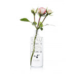Kure Bazaar Eau Dissolvante Hydratante À La Rose – clear glass bottle, pink roses, white background – nail care