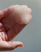No. 296 Sea Salt Scrub Bergamot/Patchouli – pink scrub in hand, gray background – body care