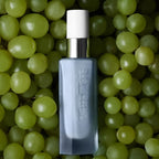 The Beautiful Night Potion – gray bottle with white spray nozzle, green grape background – skin care