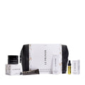 Le Prunier Signature Mini Set – weiße Verpackung mit schwarzer Tasche, verschiedene Mini-Produkte, weißer Hintergrund – Hautpflege