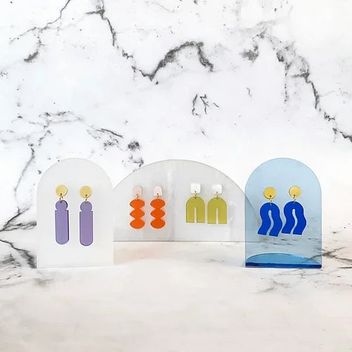 Spectral Orange – colorful earrings on acrylic display, marble background – accessories