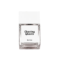 Chasing Ghosts Parfum – clear glass bottle with white label and cap, white background – perfume