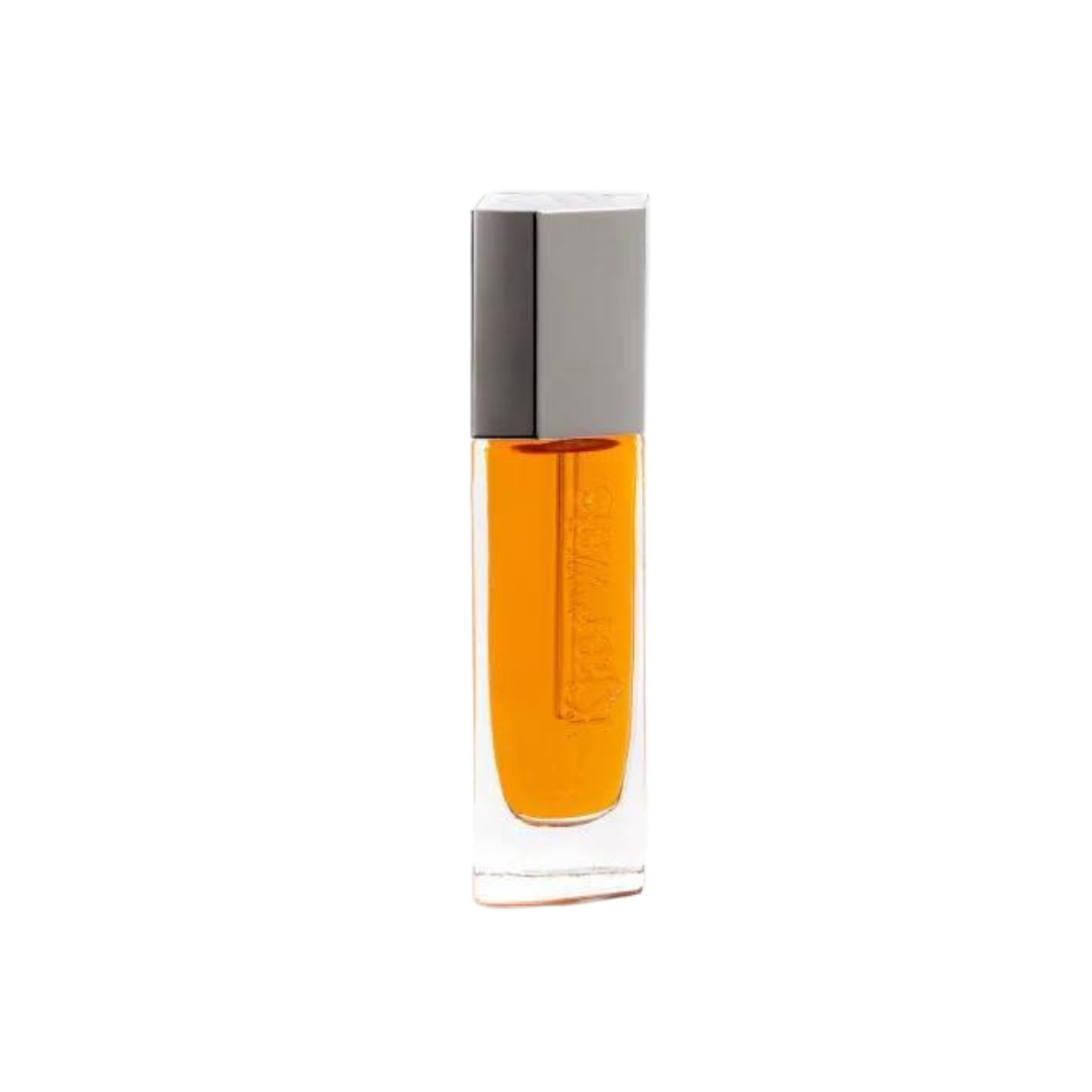 The Beautiful Oil Travel – klares Glasfläschchen mit orangefarbenem Öl, grauem Deckel, weißem Hintergrund – Hautpflege