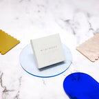 Mimi Mono Spectral Blue – white square packaging, marble background – skin care