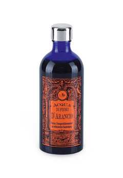 Acqua di Fiori D'Arancio – dark blue glass bottle with silver cap, white background – facial water