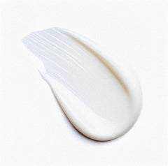 Close-up of the white texture of the After Sun Lotion on a white background for skin care