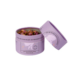 Cosmic Dealer Cacao & Double Rose Ayurvedic Tea – purple cylinder box with lid, white background – wellness tea