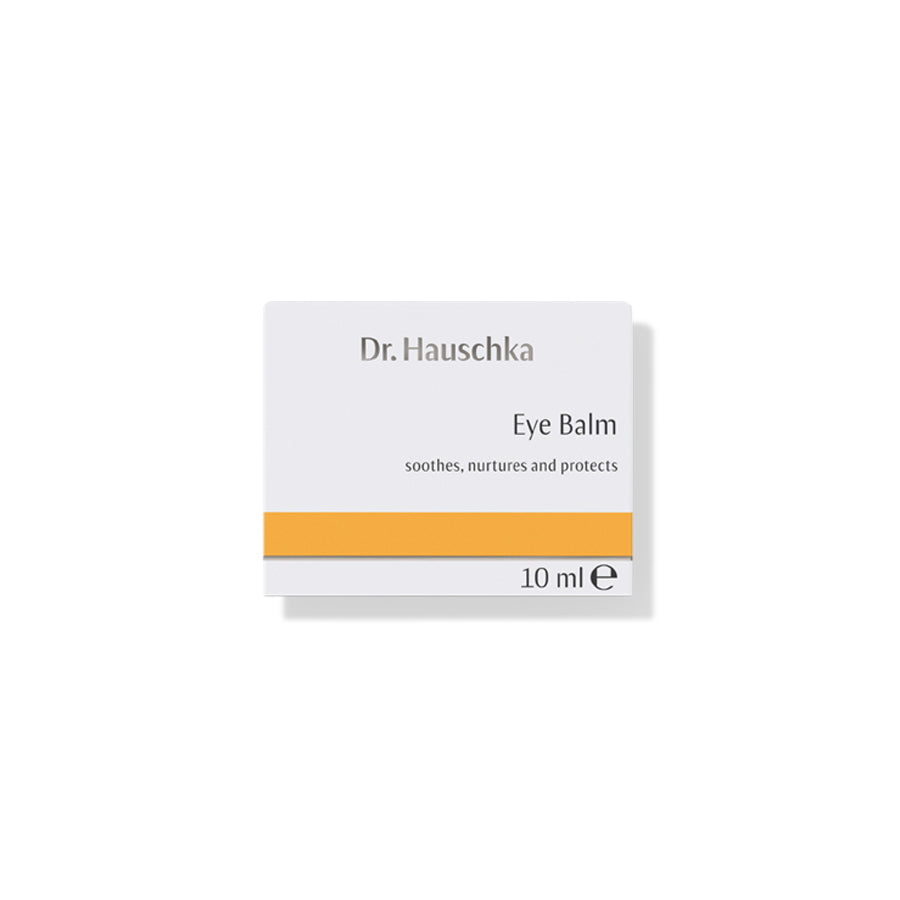 Dr. Hauschka Augenbalsam – weißes Kartonpaket 10 ml mit orangefarbenem Streifen, weißer Hintergrund – Augenpflege