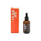 Le Rub Glow Drops SPF 50 in einer braunen Glasflasche mit Pipette vor weißem Hintergrund, Hautpflege