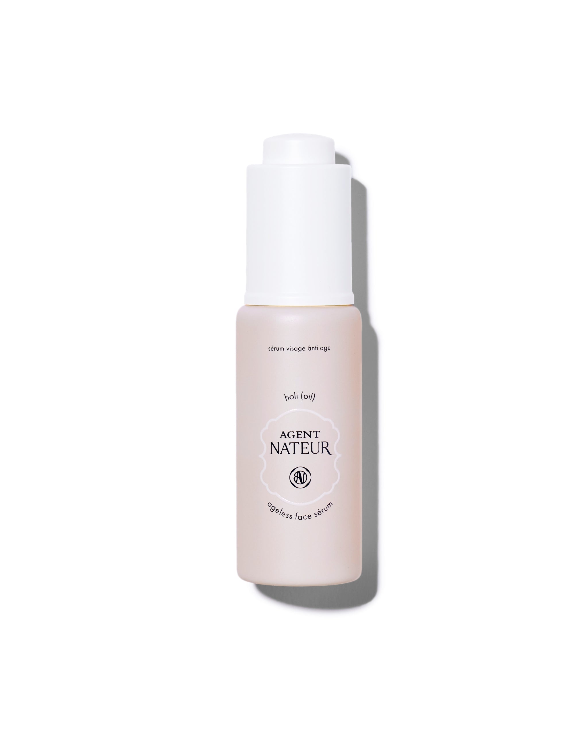 Agent Nateur Holi (oil) Ageless Face Sérum in einer blassrosa Flasche mit weißem Pumpspender für die Hautpflege.