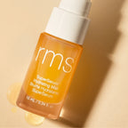 RMS Beauty SuperSerum Hydrating Mist orange spray bottle with white cap on beige background, skin care
