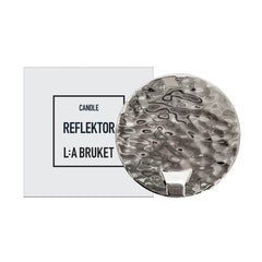 L:A Bruket Candle Reflektor, silver hammered metal candle reflector on white background, home accessory.
