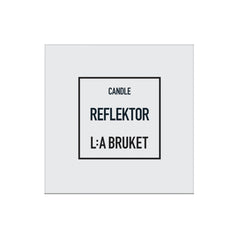 L:A Bruket Candle Reflektor in a white square package against a light background, home spa accessory.
