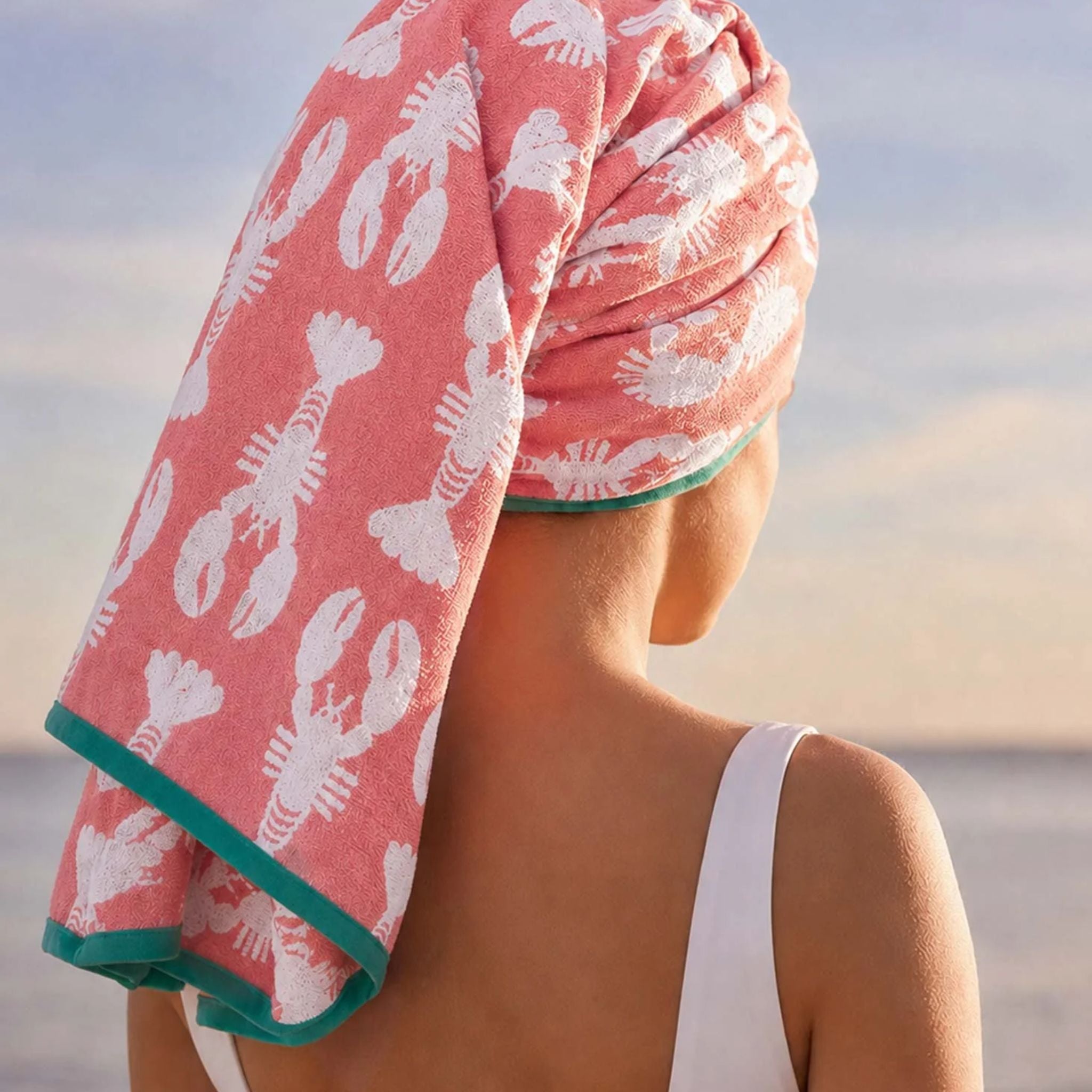 Lobster Pink Organic Cotton Bath Towel in coral with lobster print worn as a hair wrap, bath accessories